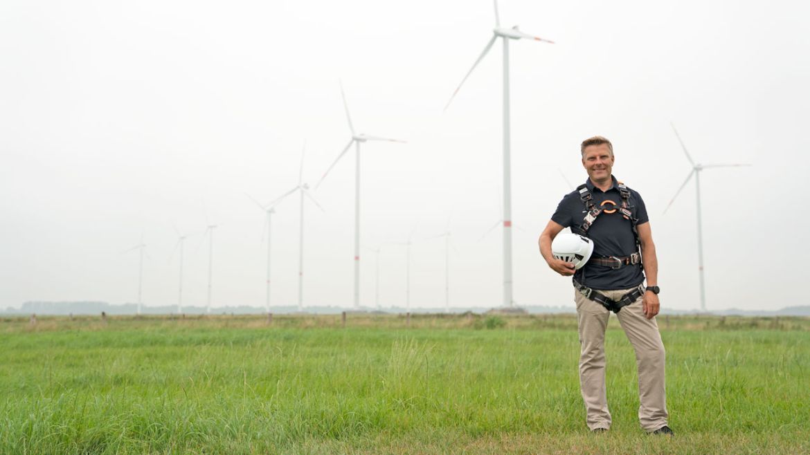 Man in front of wind turbine